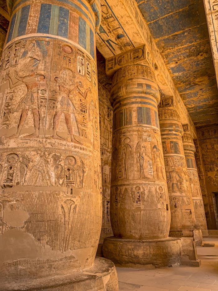 Intricately carved columns in the Luxor Temple, showcasing ancient Egyptian art and architecture.