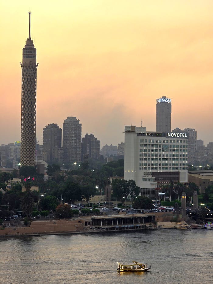 Breathtaking view of Cairo's skyline featuring the Cairo Tower and Nile River at sunset.