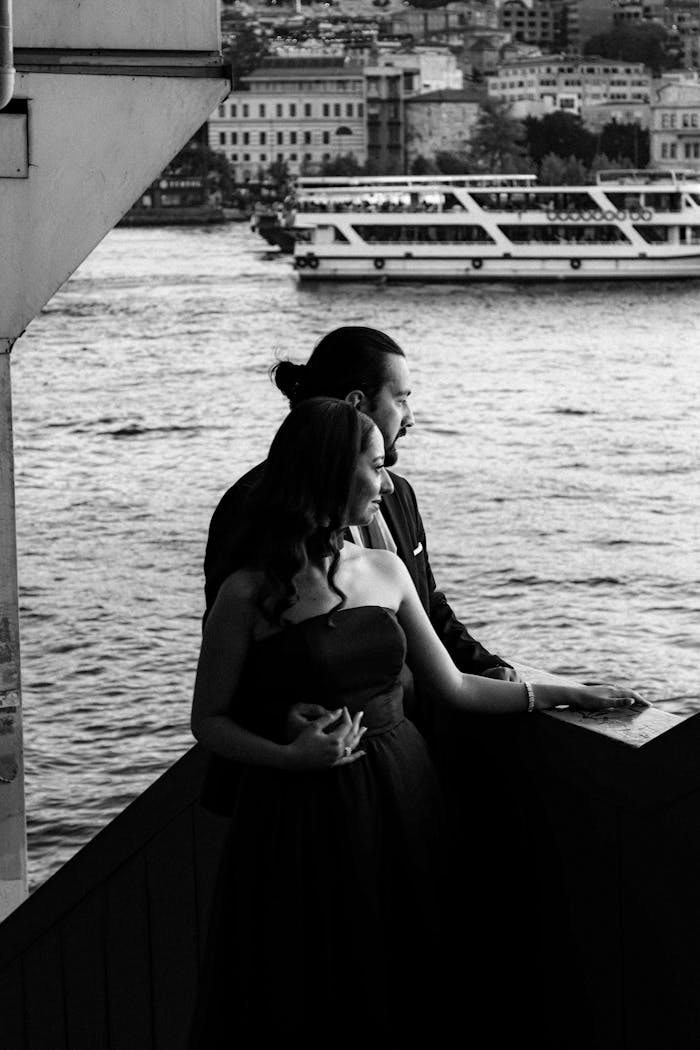 A couple enjoying a serene riverside view, capturing a moment of romance and tranquility.